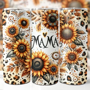 May include: A white tumbler with a leopard print design and a floral pattern featuring sunflowers. The tumbler has the word "MAMA" written on it with a heart.