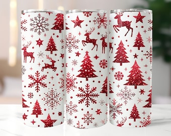May include: Three cylindrical tumblers featuring a white background with a repeating pattern of red glittery Christmas trees, reindeer, snowflakes, and stars. Each tumbler has a metallic rim at the top and a smooth, straight-sided design.