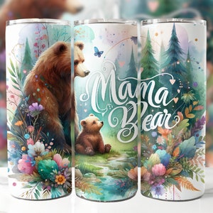 May include: Three stainless steel tumblers with a watercolor design of a mama bear and a baby bear in a forest setting. The tumblers have the text "Mama Bear" printed on them.