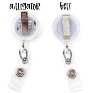 May include: Two clear plastic retractable badge holders with alligator clips and belt clips. The clips are silver and the holders are clear.