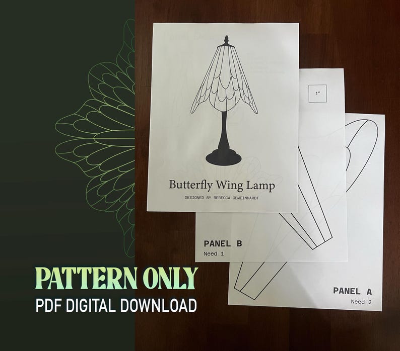 May include: A stack of white paper sheets featuring a butterfly wing lamp design, with the text "Butterfly Wing Lamp" and "Pattern Only PDF Digital Download". Additional sheets show panel diagrams. The design is by Rebecca Gemeinhardt.