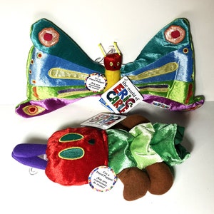 May include: Two plush hand puppets from The Very Hungry Caterpillar by Eric Carle. The butterfly puppet is green, blue, purple, and yellow with red and orange accents. The caterpillar puppet is red with green and brown accents. Both puppets have a tag that says "I'm a Hand Puppet! Soy una marioneta de mano!"