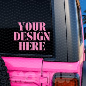 May include: A pink vehicle with a black rear window featuring the text "YOUR DESIGN HERE" in pink. The vehicle's body is a vibrant pink, with a black tire visible on the side. The image is a close-up of the vehicle's rear.