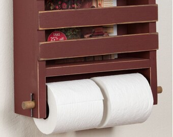 May include: A red wooden wall-mounted organizer with three shelves and a double toilet paper roll holder. The organizer has a distressed finish and is decorated with a sign that says "Sturbridge Yankee Workshop Annual Lighting Sale".