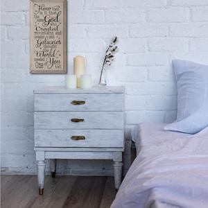 May include: A wooden sign with a white background and black text. The text reads: "How cool is it that the same God who Created mountains and oceans and Galaxies thought the World needed You too."