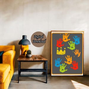 May include: A digital download of a printable art print featuring a gray background with colorful handprints and a yellow crown. The handprints are in shades of red, orange, yellow, green, blue, and purple.