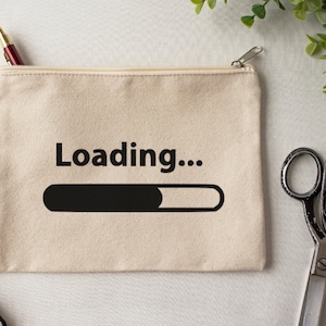 May include: A beige canvas zippered pouch with the text "Loading..." and a black progress bar graphic.