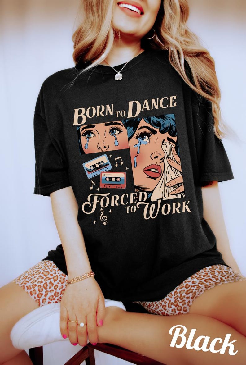 May include: Black t-shirt with a retro comic book style graphic of a woman crying with the text "Born to Dance Forced to Work" and cassette tapes.
