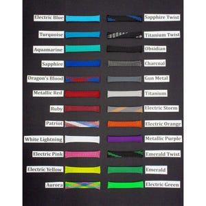 May include: A collection of twenty-eight tubular mesh sleeves arranged in two columns, each labeled with its color name including Electric Blue, Sapphire Twist, Turquoise, Titanium Twist, Aquamarine, Obsidian, Sapphire, Charcoal, Dragon's Blood, Gun Metal, Metallic Red, Titanium, Ruby, Electric Storm, Patriot, Electric Orange, White Lightning, Metallic Purple, Electric Pink, Emerald Twist, Electric Yellow, Emerald, Aurora, and Electric Green.