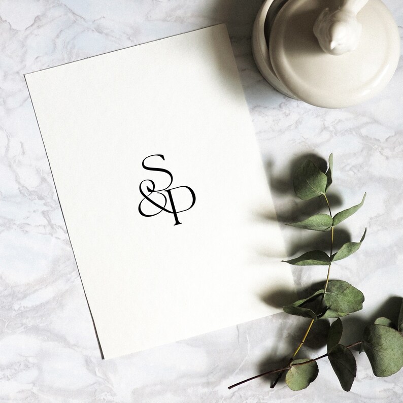 May include: A white card with the letters "S & P" in a stylized font.