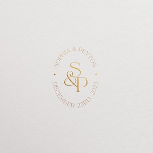 May include: Gold circle with the text "Sophia & Peyton" and "December 23rd, 2023" around the outside. The initials "S&P" are in the center.