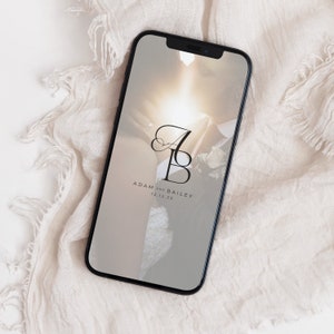 May include: A smartphone screen displaying a wedding announcement with a photo of a couple and the text "Adam and Bailey 12.12.23".