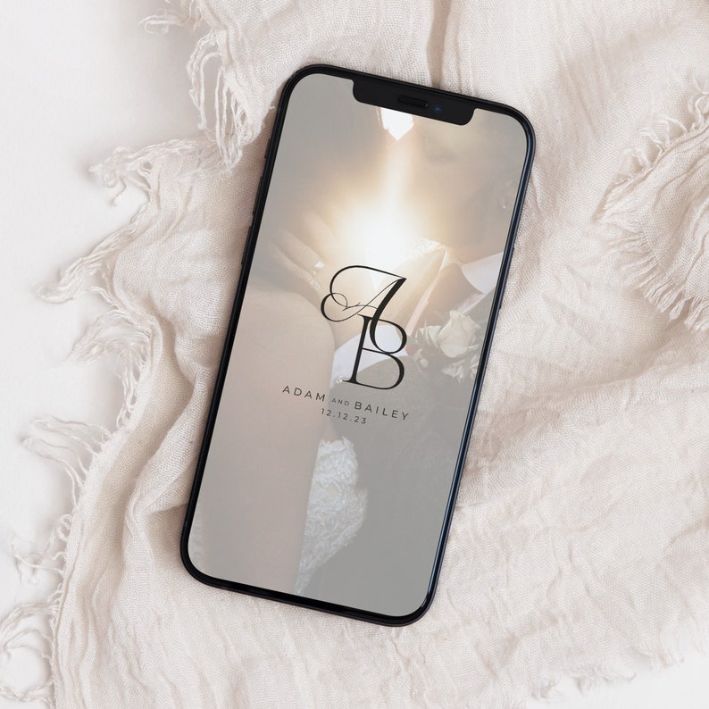 May include: A smartphone screen displaying a wedding announcement with a photo of a couple and the text "Adam and Bailey 12.12.23".