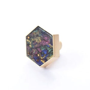 May include: A hexagonal cabinet knob with a gold metal frame and a colourful iridescent glass insert.