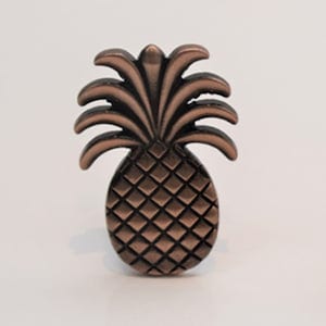 May include: A copper pineapple-shaped decorative knob with a detailed textured design.