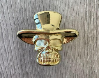 Perilla con forma de calavera con sombrero - dorada