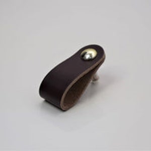 May include: A dark brown leather cabinet pull with a silver metal knob.