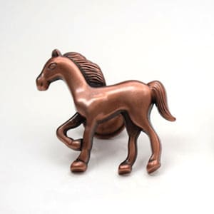 May include: A copper-coloured metal horse figurine. The horse is running with its head turned to the side. The figurine is a decorative piece for a home or office.