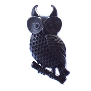 May include: A black metal owl figurine with a textured surface. The owl is perched on a branch with its wings spread out.