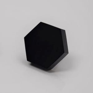 May include: A black hexagonal shaped object. The object is smooth and has a glossy finish.