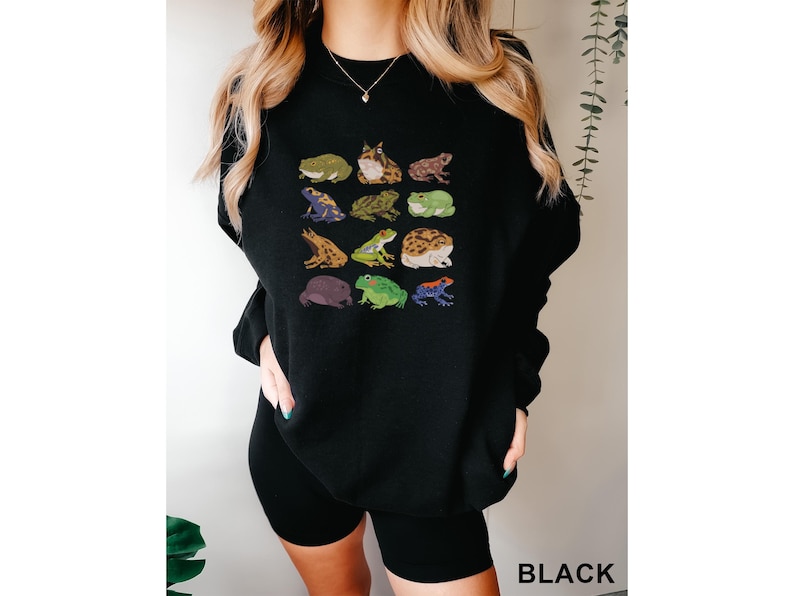 a woman wearing a black sweatshirt with animals on it