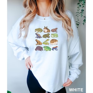 a woman wearing a white sweatshirt with animals on it