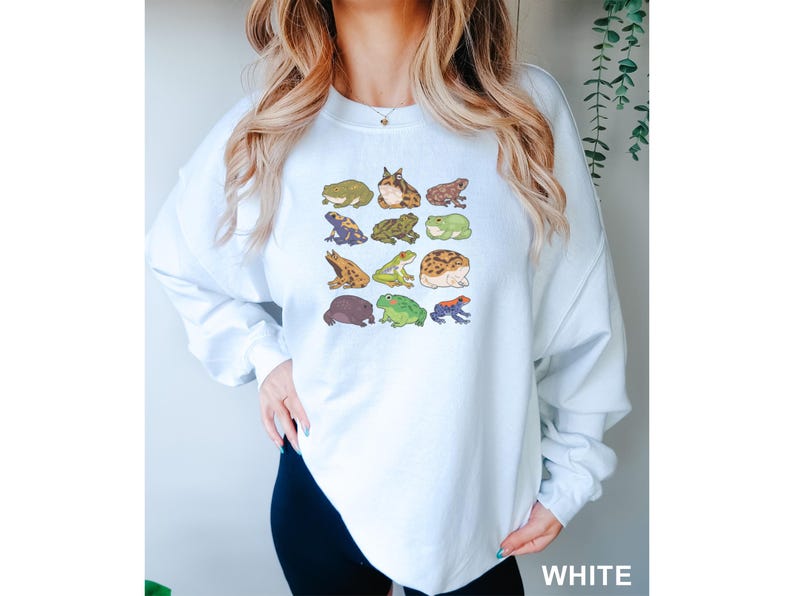 a woman wearing a white sweatshirt with animals on it