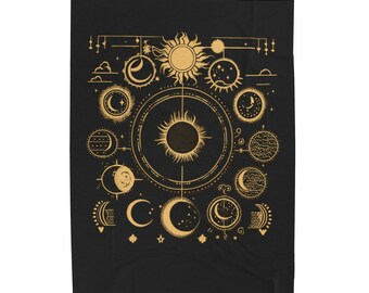 May include: A black tapestry with a gold design of the sun and moon in various phases. The design is intricate and detailed, with a celestial theme.