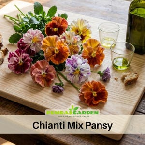 May include: A collection of colorful Chianti Mix Pansy flowers in shades of orange, yellow, purple, and burgundy, arranged on a wooden cutting board. The image includes two small glasses with a green liquid, a bottle, and a piece of bread.