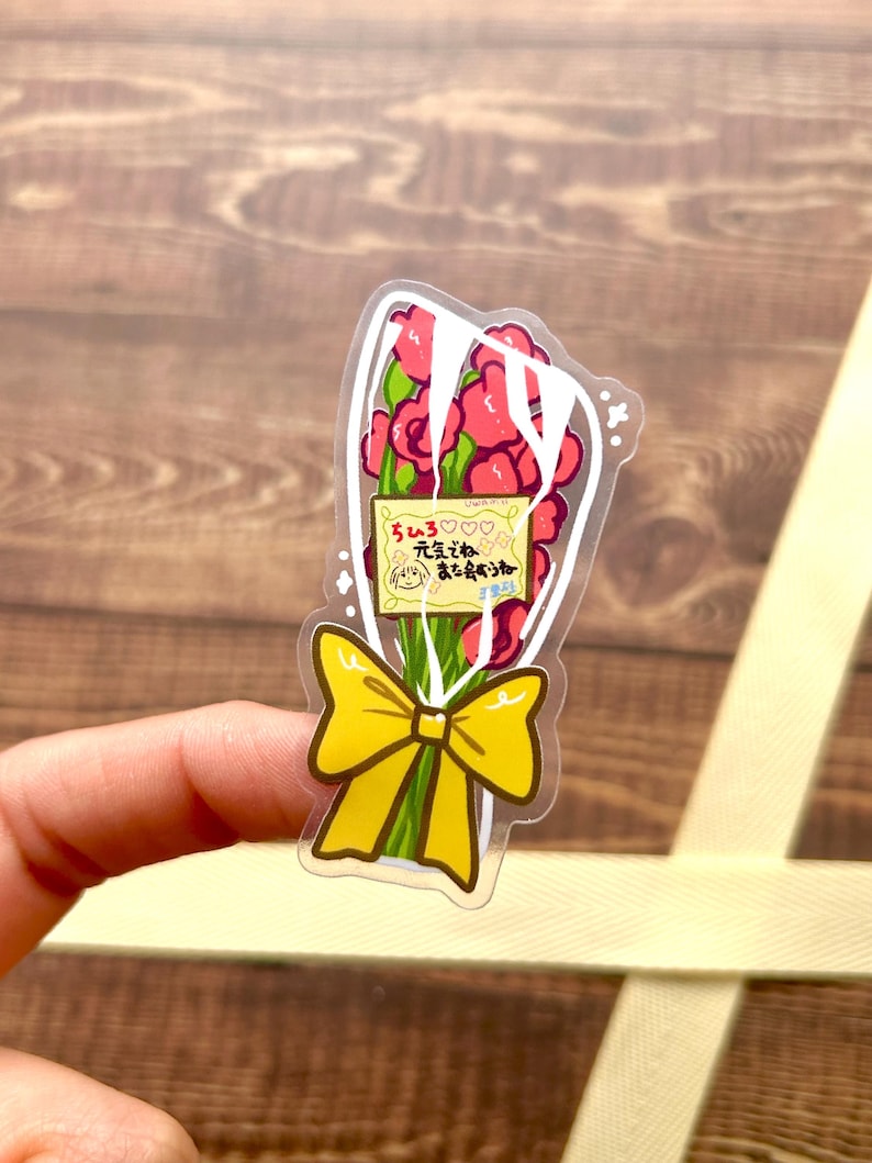 May include: A clear sticker with a bouquet of red roses tied with a yellow bow. The sticker has a small note that says "Thank you for always being there for me." in Japanese.