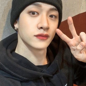 May include: A person wearing a black beanie with a white label that says "..." and a black hoodie with white text that says "Collection Name - M.S. Good x Jail."