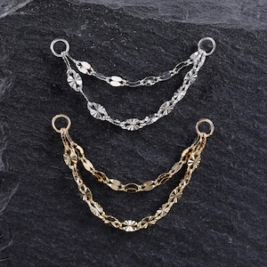 May include: Two double-strand chain connectors, one in silver tone and one in gold tone. Each piece features two delicate, textured oval-link chains suspended between two circular jump rings, designed for jewelry assembly and decorative attachment.