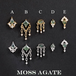May include: Ten moss agate jewelry pieces labeled A through E, shown in gold and silver tones. Each piece features green moss agate stones and small clear accent stones. The collection includes various shapes like kite, oval, and round settings.