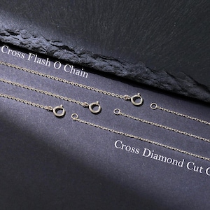 May include: Two different types of silver chains, one labeled "Cross Flash O Chain" and the other labeled "Cross Diamond Cut Chain".