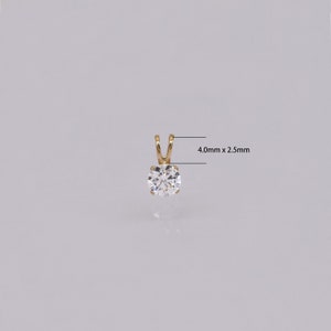 Pu&ograve; includere: Un pendente in oro con una gemma rotonda e trasparente. Il pendente misura 4,0 mm x 2,5 mm. La gemma &egrave; incastonata in un design semplice e classico. Perfetto per l'uso quotidiano o occasioni speciali.