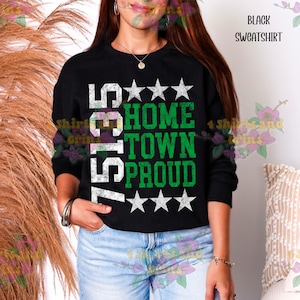May include: Black sweatshirt with the text "75135 HOME TOWN PROUD" in white and green. The sweatshirt has a crew neck and long sleeves. The text is centered on the front of the shirt, with stars above and below the words.