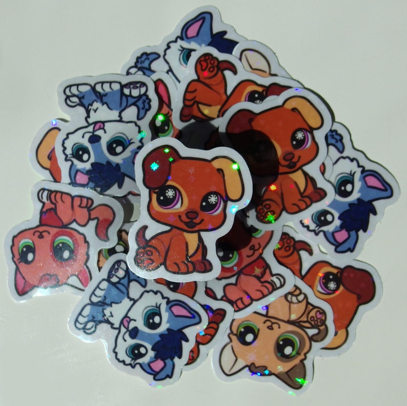 May include: A collection of colorful, holographic stickers featuring cartoon dogs with different expressions. The stickers are round and have a glossy finish.