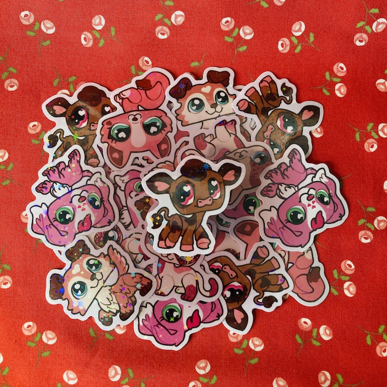 May include: A collection of colorful, glittery animal stickers. The stickers feature various animals, including a cow, a dog, a cat, and a pig. The stickers are all in a cartoon style and have a whimsical feel.