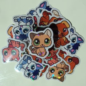 May include: A collection of colorful, glittery stickers featuring cartoon animals. The stickers are shaped like cats, dogs, and other animals. They are perfect for adding a touch of whimsy to any project.