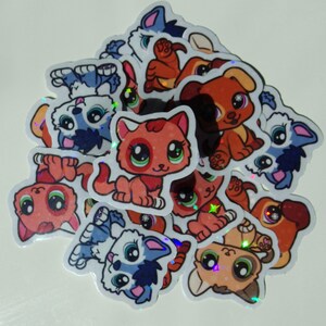 May include: A collection of colorful holographic stickers featuring cartoon animals. The stickers feature cats, dogs, and other animals with large eyes and cute expressions. The stickers are perfect for adding a touch of whimsy to laptops, water bottles, or other surfaces.