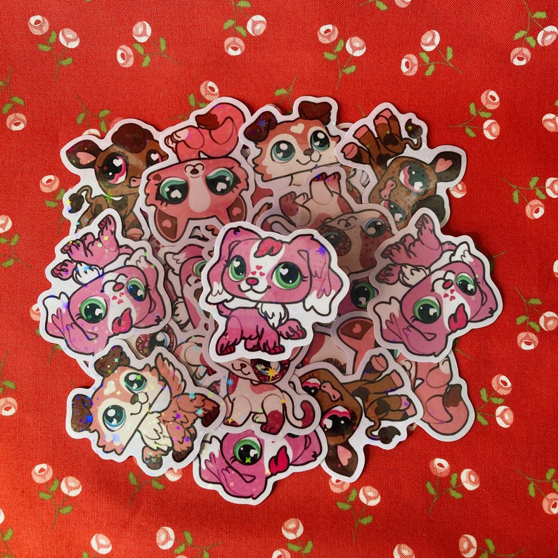 May include: A collection of colorful, glittery stickers featuring cartoon dogs and cats. The stickers are on a red background with white flowers.