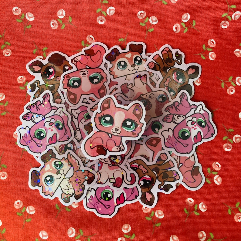 May include: A collection of pink and brown glitter stickers featuring cartoon animals with large eyes. The stickers are arranged in a circle on a red background with white flowers.