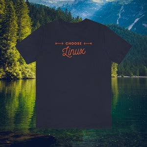 May include: Navy blue t-shirt with the orange text "CHOOSE Linux". The text is centered. The shirt is made of a soft material. Ideal for casual wear.