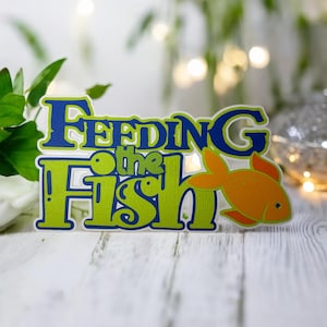 Abbellimento fustellato per album di ritagli Feeding the Fish - completamente assemblato da cartoncino di qualità a strati