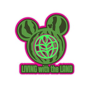 Op de afbeelding: Een sticker met een groen Mickey Mouse-hoofdontwerp met een watermeloenpatroon. Binnenin de kop bevindt zich een groene wereldbol met een plantontwerp. De sticker heeft een roze omtrek en de tekst "LIVING with the LAND" in het groen.