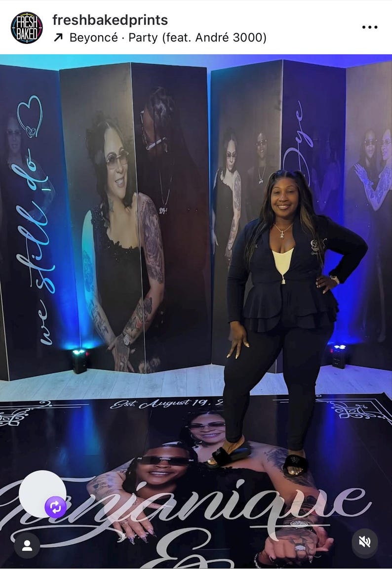 May include: A woman stands in front of a backdrop featuring large portraits. The backdrop includes the text "we still do" and "Jye". A floor graphic displays the name "Janique" and the date "Est. August 19. 2".
