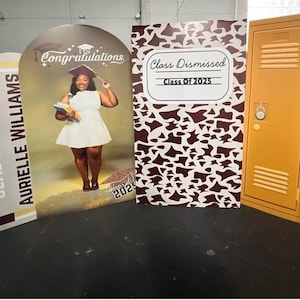 May include: A graduation-themed display featuring a student in a white dress and cap, with the text "Congratulations" and "Class of 2025." Additional signs read "Senior 2025" and "Class Dismissed."