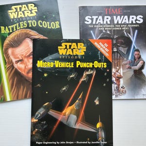 May include: Three Star Wars books are displayed. One is titled "Battles to Color," another is a Time special edition, and the third is "Micro-Vehicle Punch-Outs." The "Micro-Vehicle" book features a yellow and white spaceship with red laser beams.