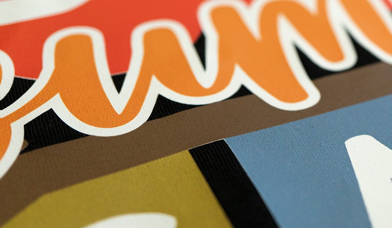 May include: Close-up of a colorful fabric with the word "Summer" written in orange and white letters.