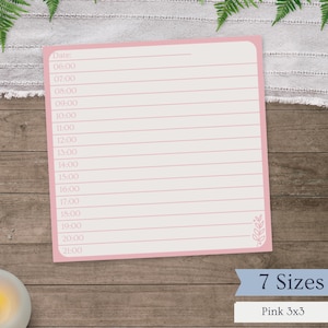 May include: A pink 3x3 inch daily planner notepad with a pink border and lined pages. The notepad has time slots from 6:00 to 21:00. The text "7 Sizes" is visible. The notepad is on a wooden surface.
